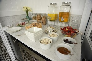 A breakfast buffet with various food items and beverages.