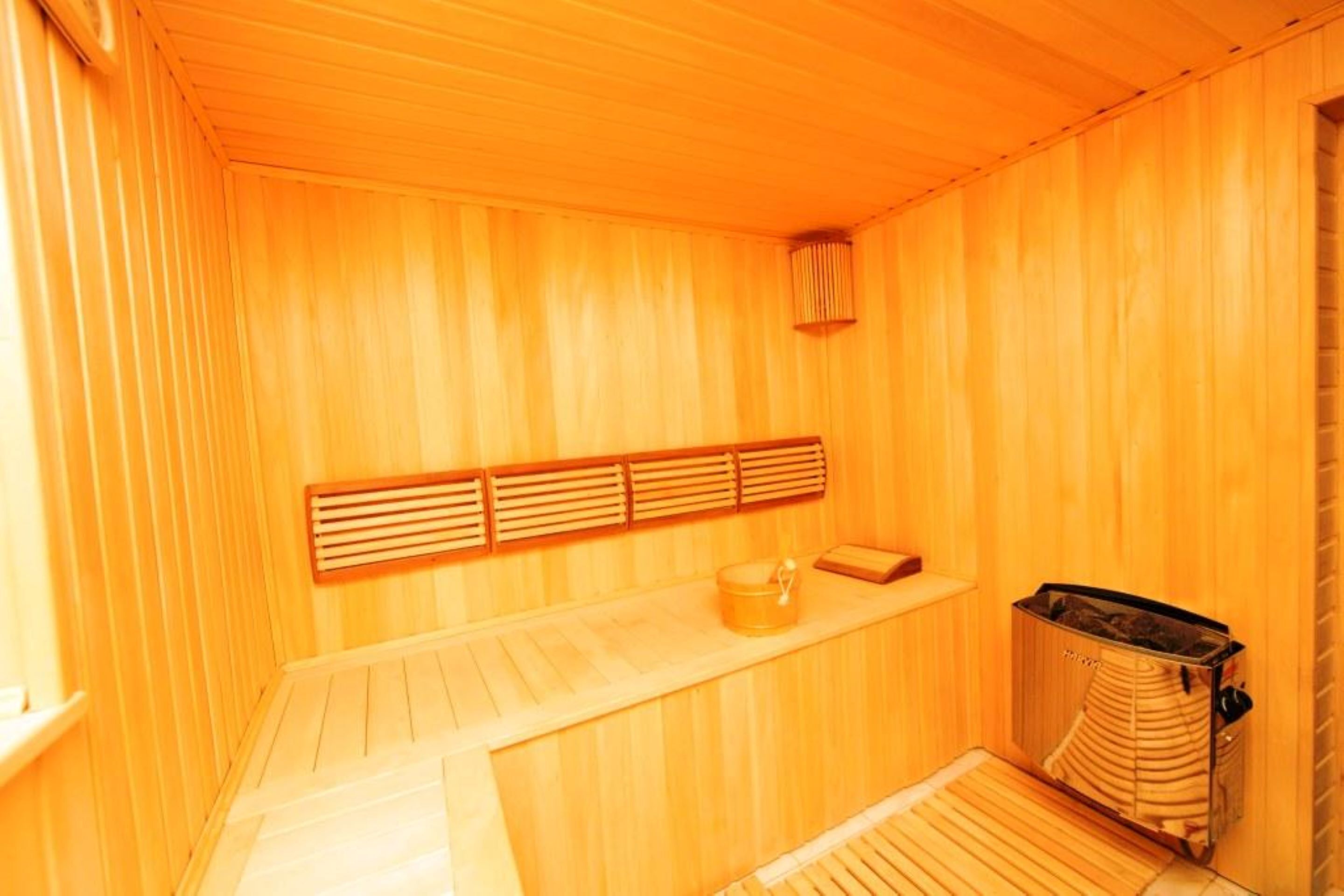 A sauna room with wooden walls and benches.