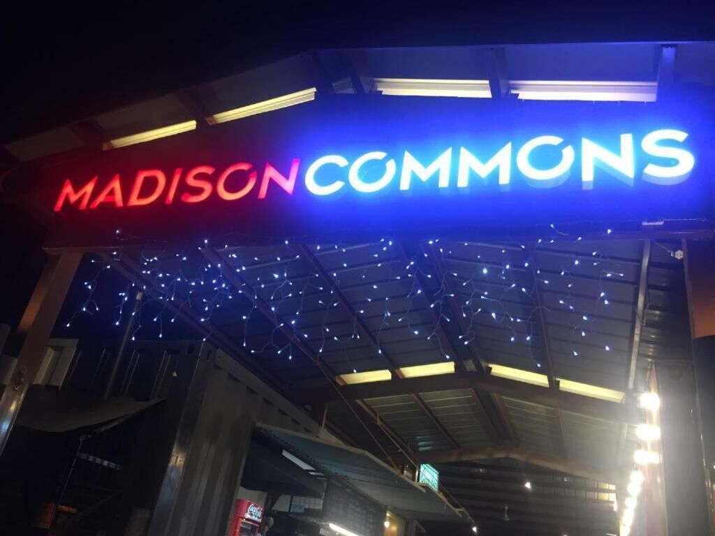 El exterior de un edificio con un letrero llamativo que dice "MADISON COMMONS".