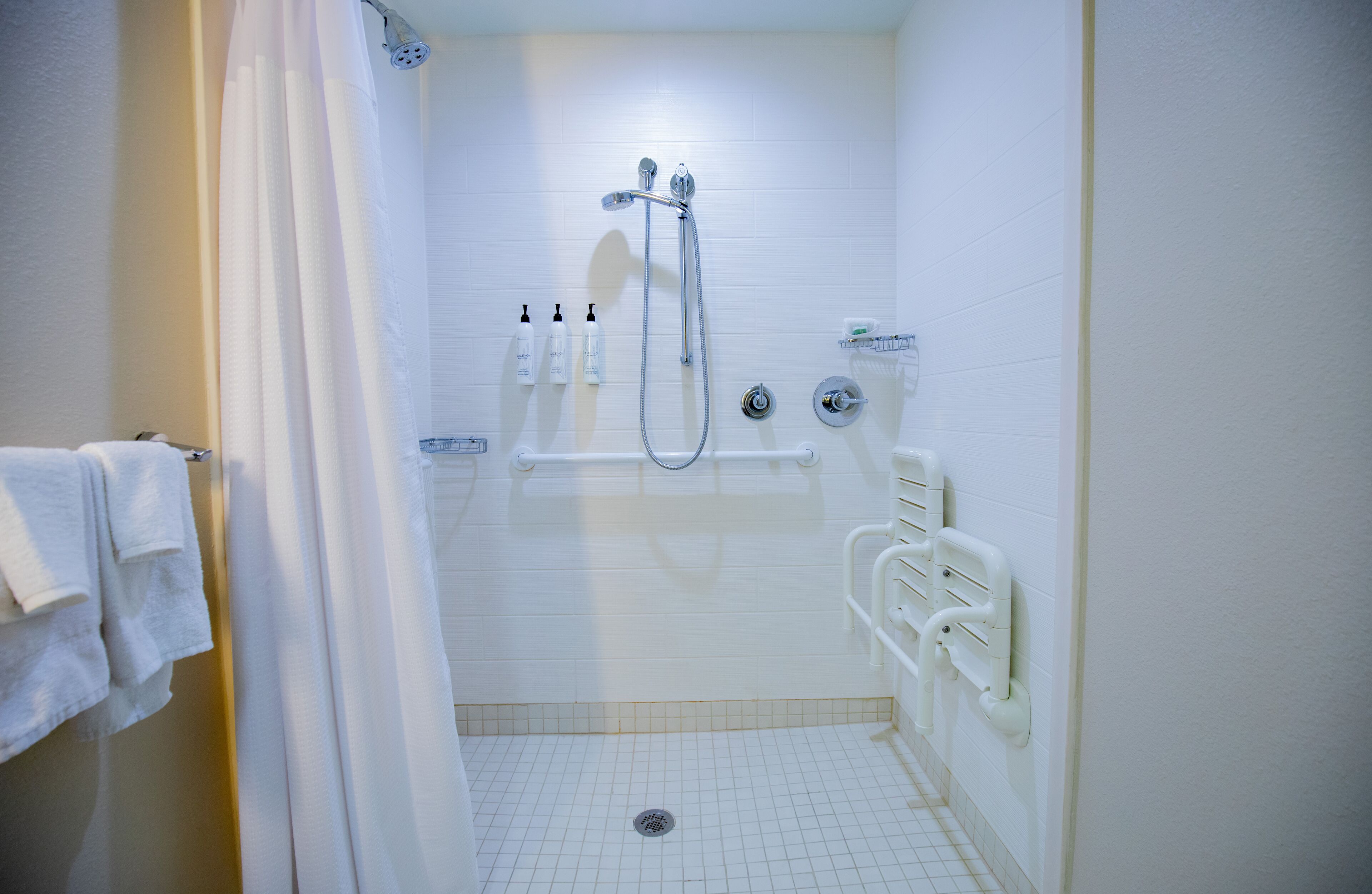 A bathroom with a shower, a toilet, and a sink.