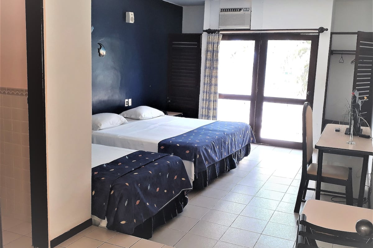 Standard Triple Room | Minibar, in-room safe, desk, laptop workspace