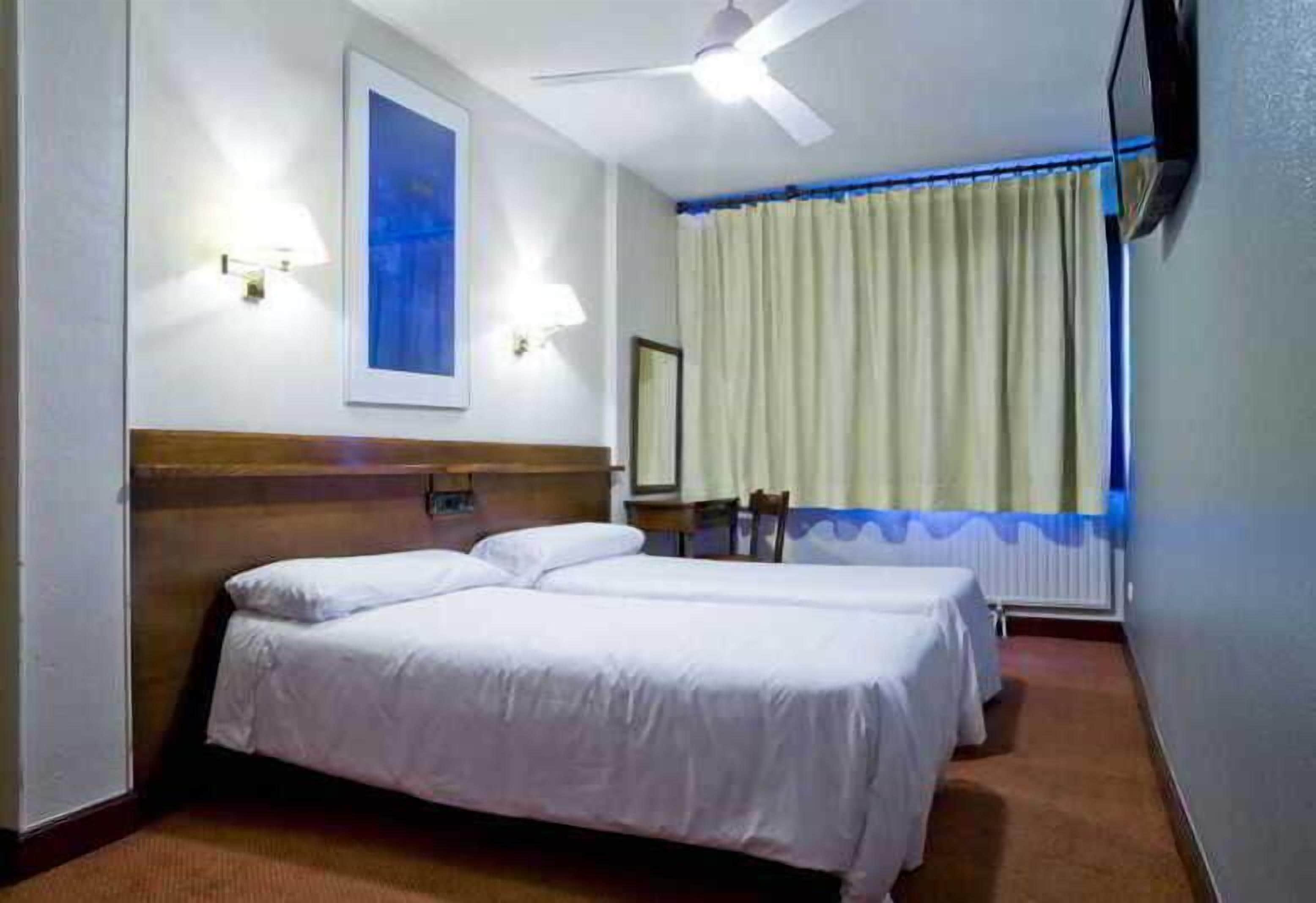Desk, blackout curtains, soundproofing, rollaway beds
