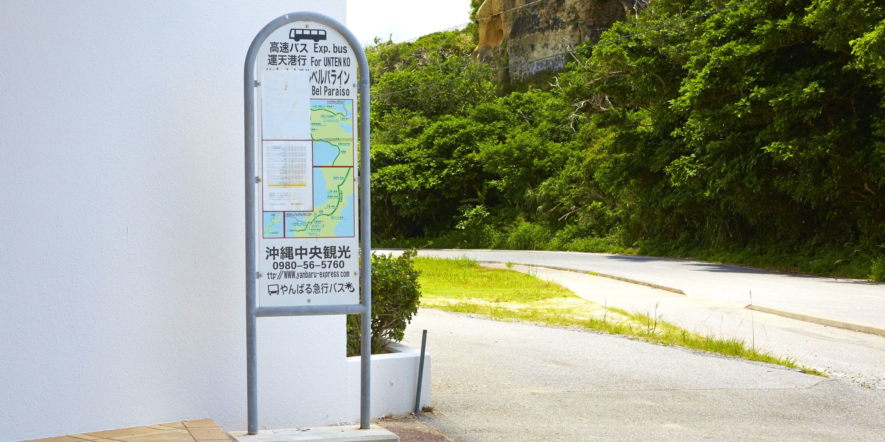 A bus stop sign with a map and contact information.