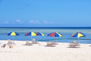 Private beach, white sand, sun loungers, beach umbrellas