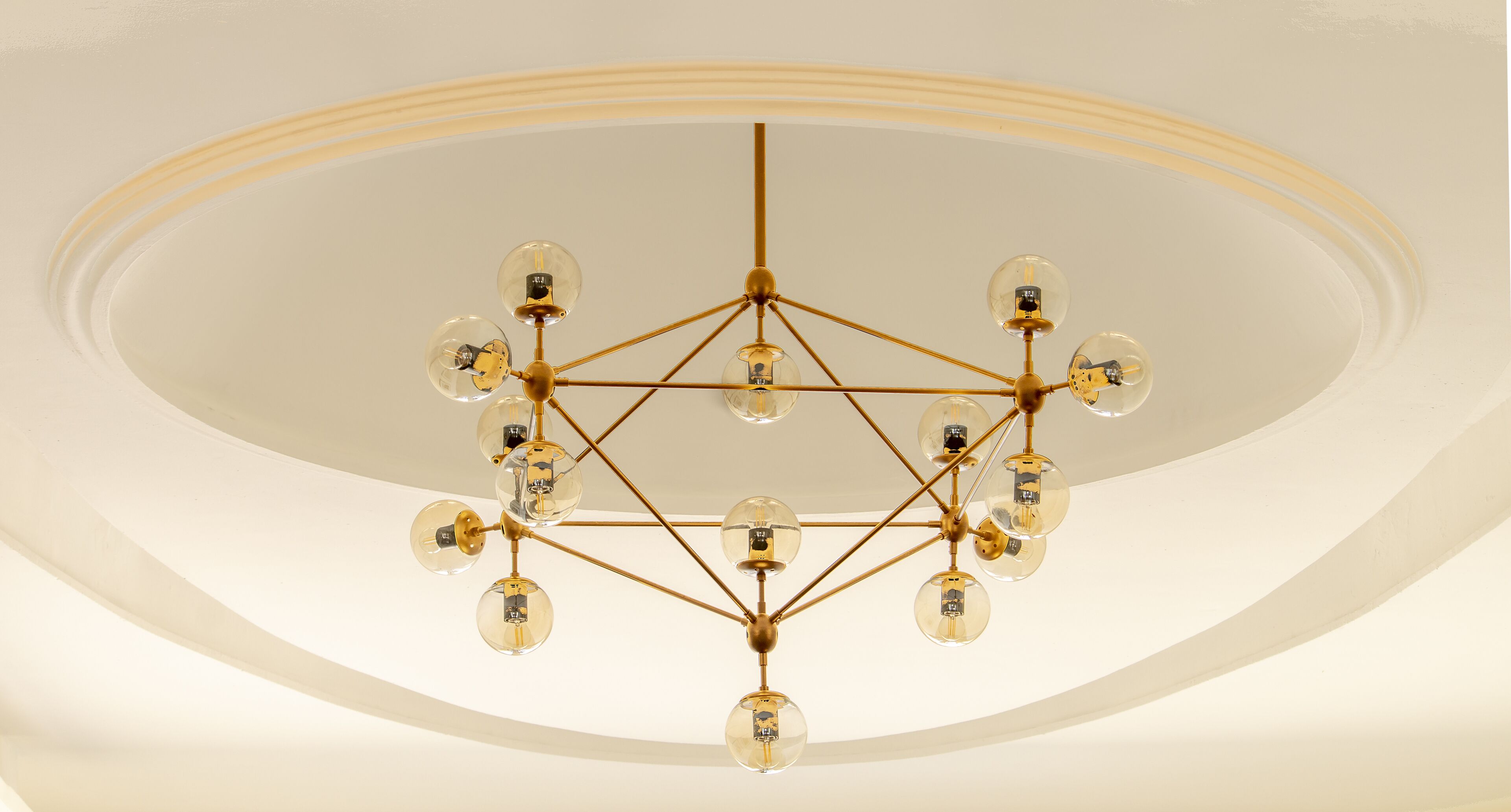A chandelier with multiple bulbs and a geometric metal frame.