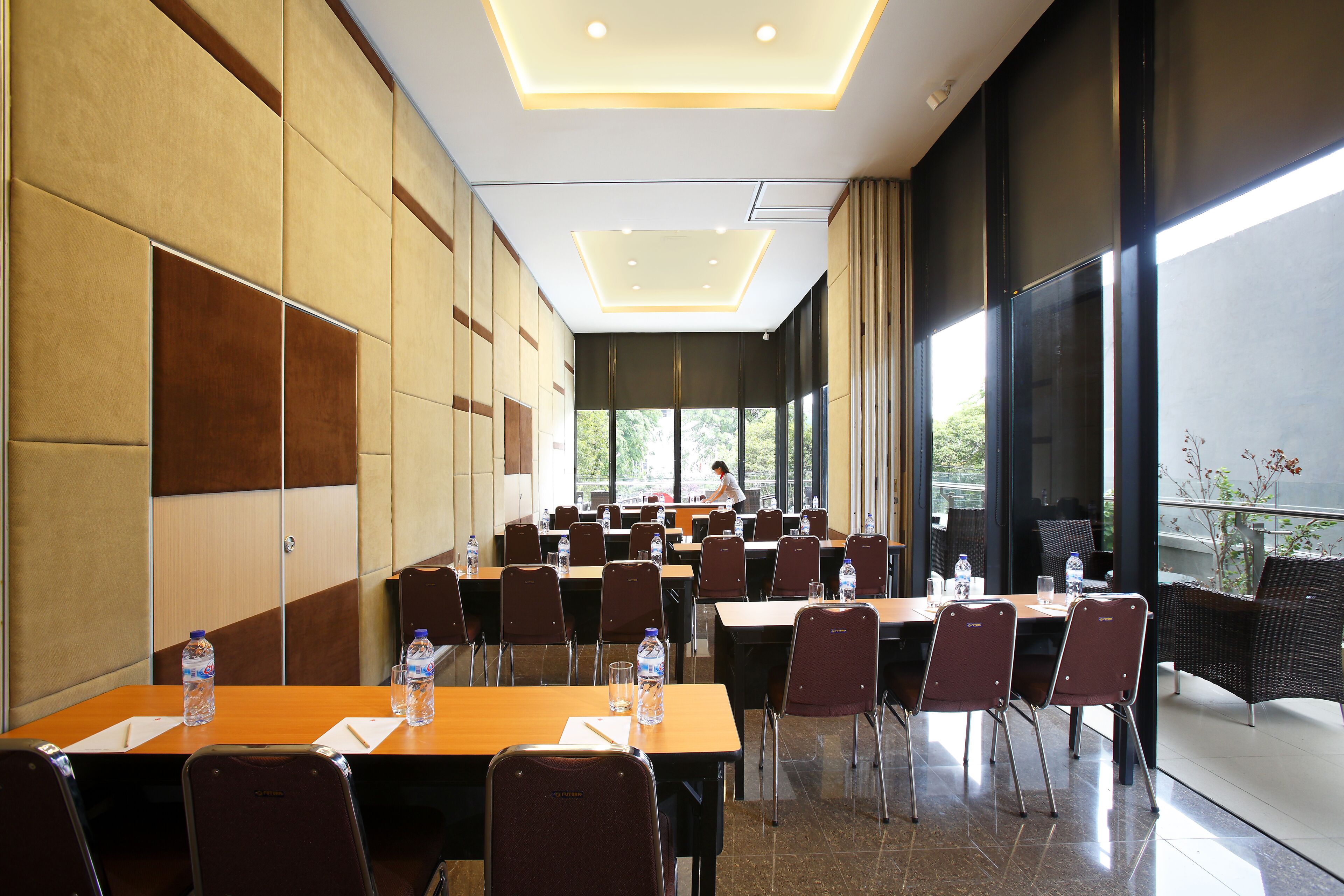 A conference room with tables, chairs, and water bottles.