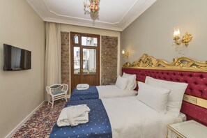 A hotel room with two beds, a television, a chair, and a view of the city through a window. - By Murat Crown Hotel (Istanbul)