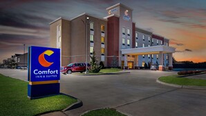 A Comfort Inn & Suites hotel with a modern design, featuring a prominent sign, a covered entrance, and a parking lot.