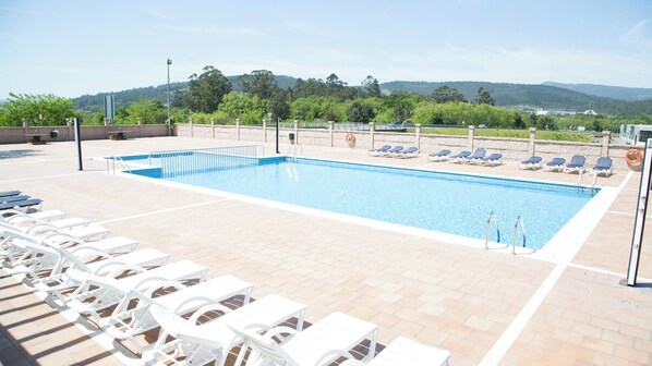 Seasonal outdoor pool, open 11 AM to 8:30 PM, pool umbrellas