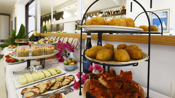 A buffet with various food items including croquettes, salads, and bread. - Best Western Hotel Martello (Lampedusa)