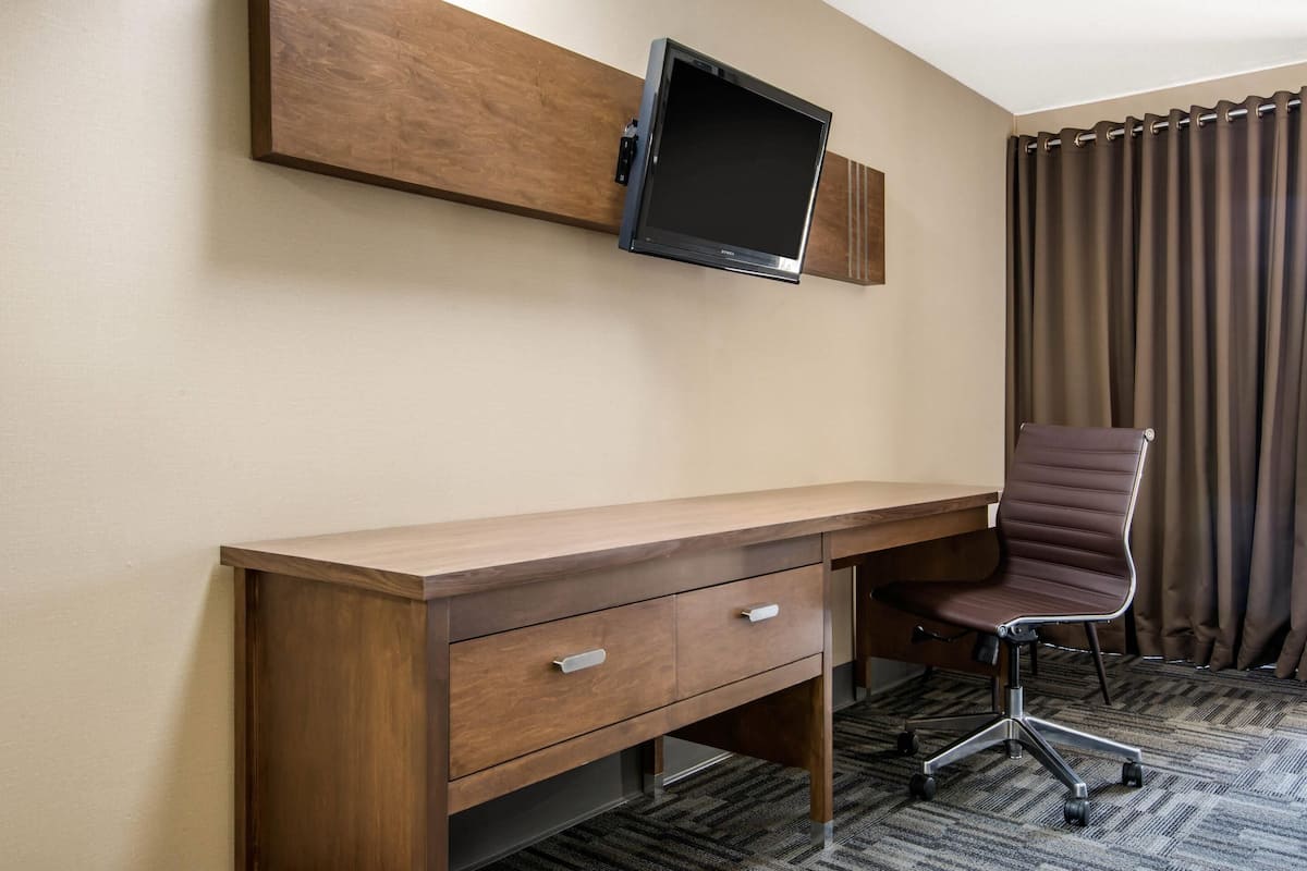Desk, laptop workspace, blackout drapes, iron/ironing board