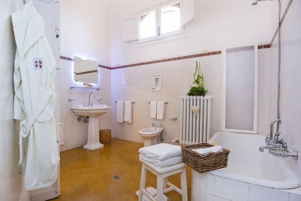 A bathroom with a bathtub, sink, and toilet.