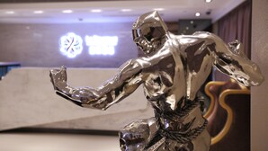 A metallic sculpture of a figure in a dynamic pose. - Le Prabelle Hotel (Kowloon)