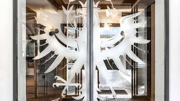 A glass door with a white decorative cut-out design.