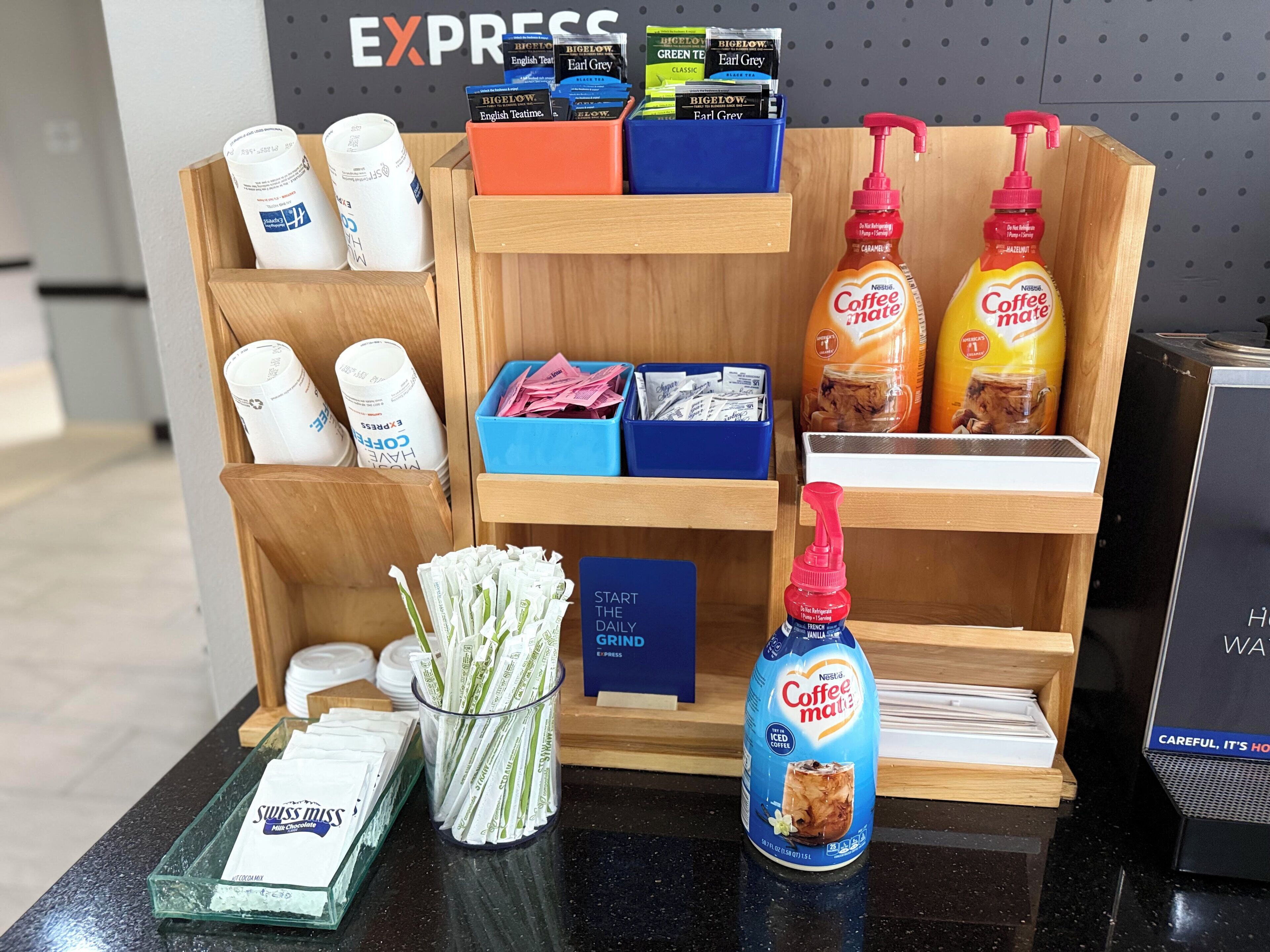 A coffee station with various coffee products and a Nestlé Coffee Mate bottle.
