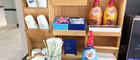 A coffee station with various coffee products and a Nestlé Coffee Mate bottle.