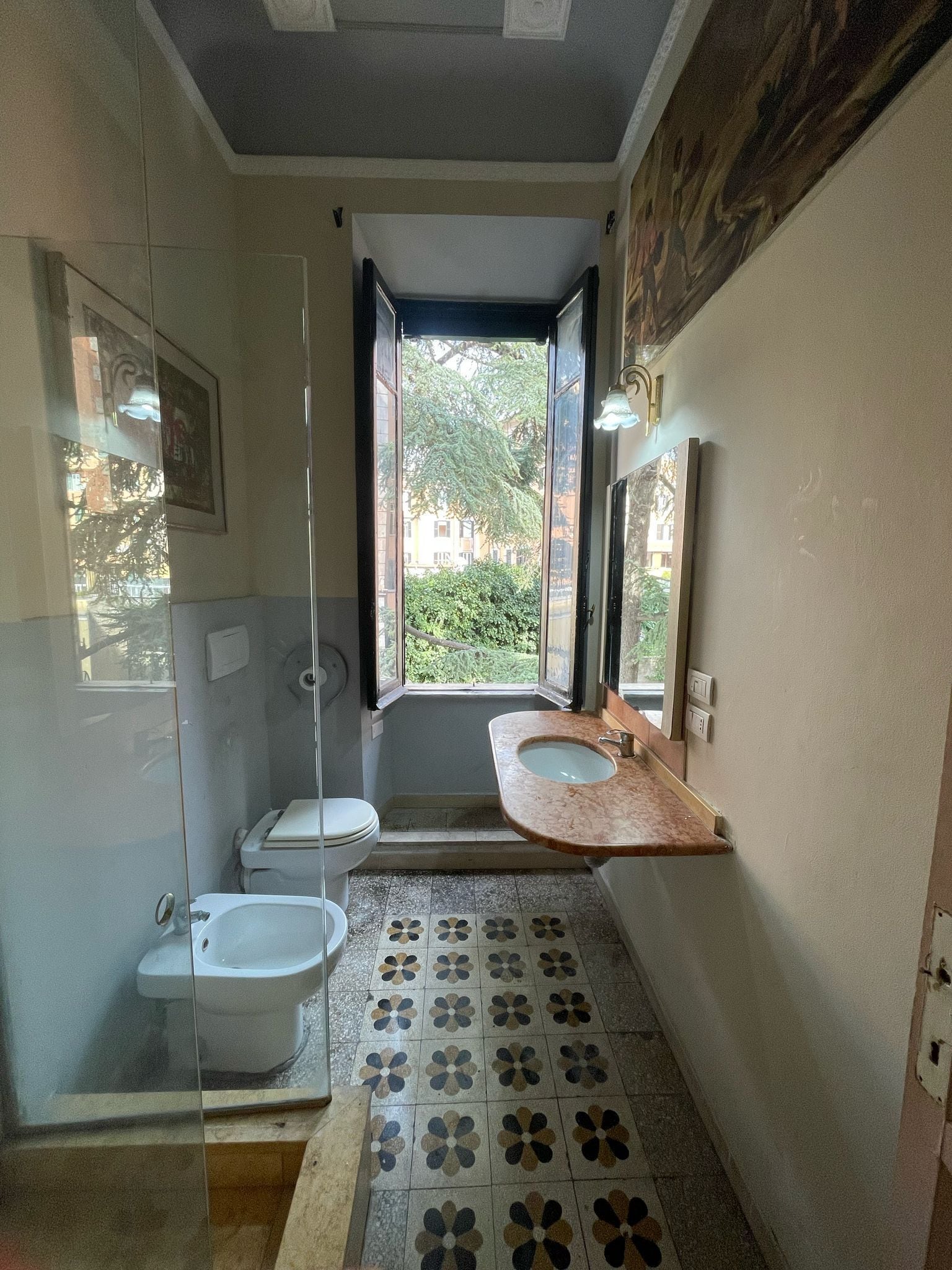 A bathroom with a toilet, bidet, and sink.