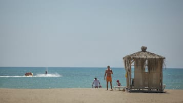 Sun loungers, beach umbrellas, beach towels, beach bar