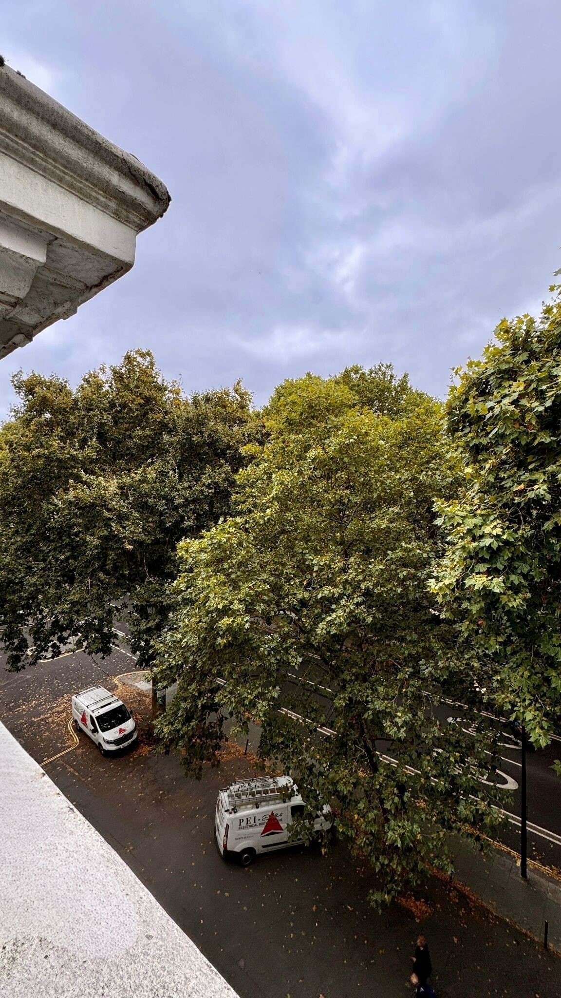 A parking area with a white van labeled "PEJ Electrical."