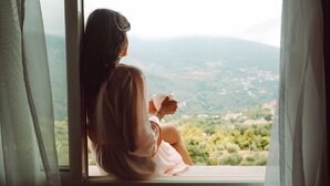 A person sitting by a window with a view of a landscape. - Le Tournant Hotel & Resort (Ehden)