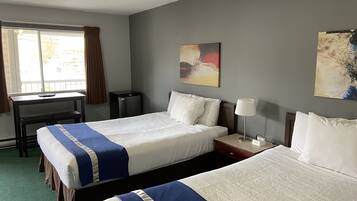 Habitación Deluxe, 2 camas Queen size | Escritorio, cortinas blackout, wifi gratis y ropa de cama