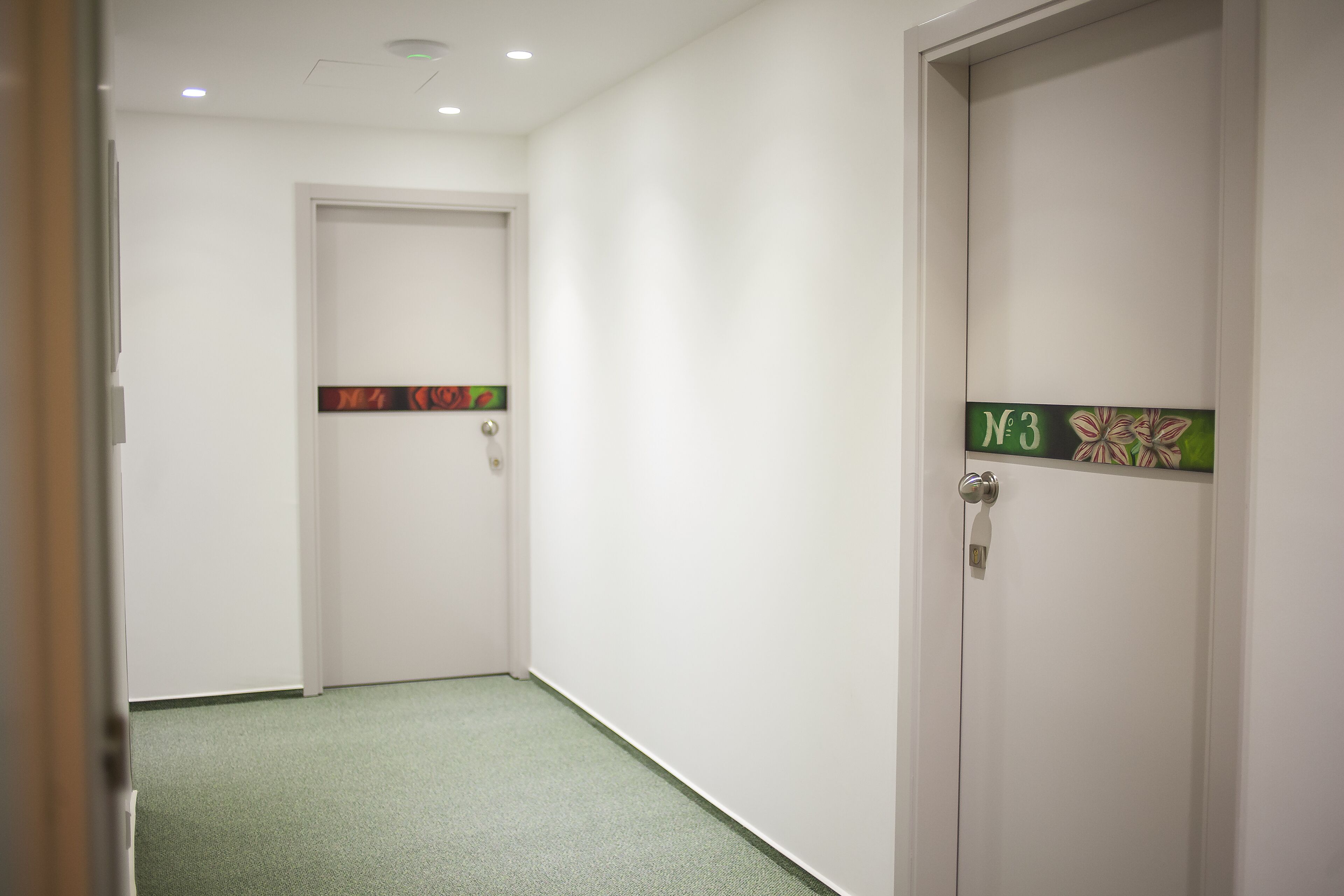 A hallway with two doors, each marked with a number.