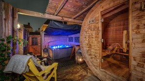 A wooden cabin with a hot tub, a wooden bench, and a lantern. - Boutique Hotel The Roosevelt (Middelburg)
