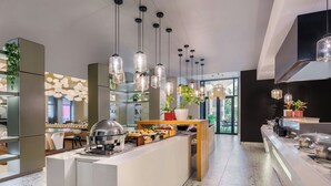 A modern kitchen with a central island, pendant lighting, and a buffet setup. - Protea Hotel Fire & Ice by Marriott Pretoria Menlyn (Pretoria)