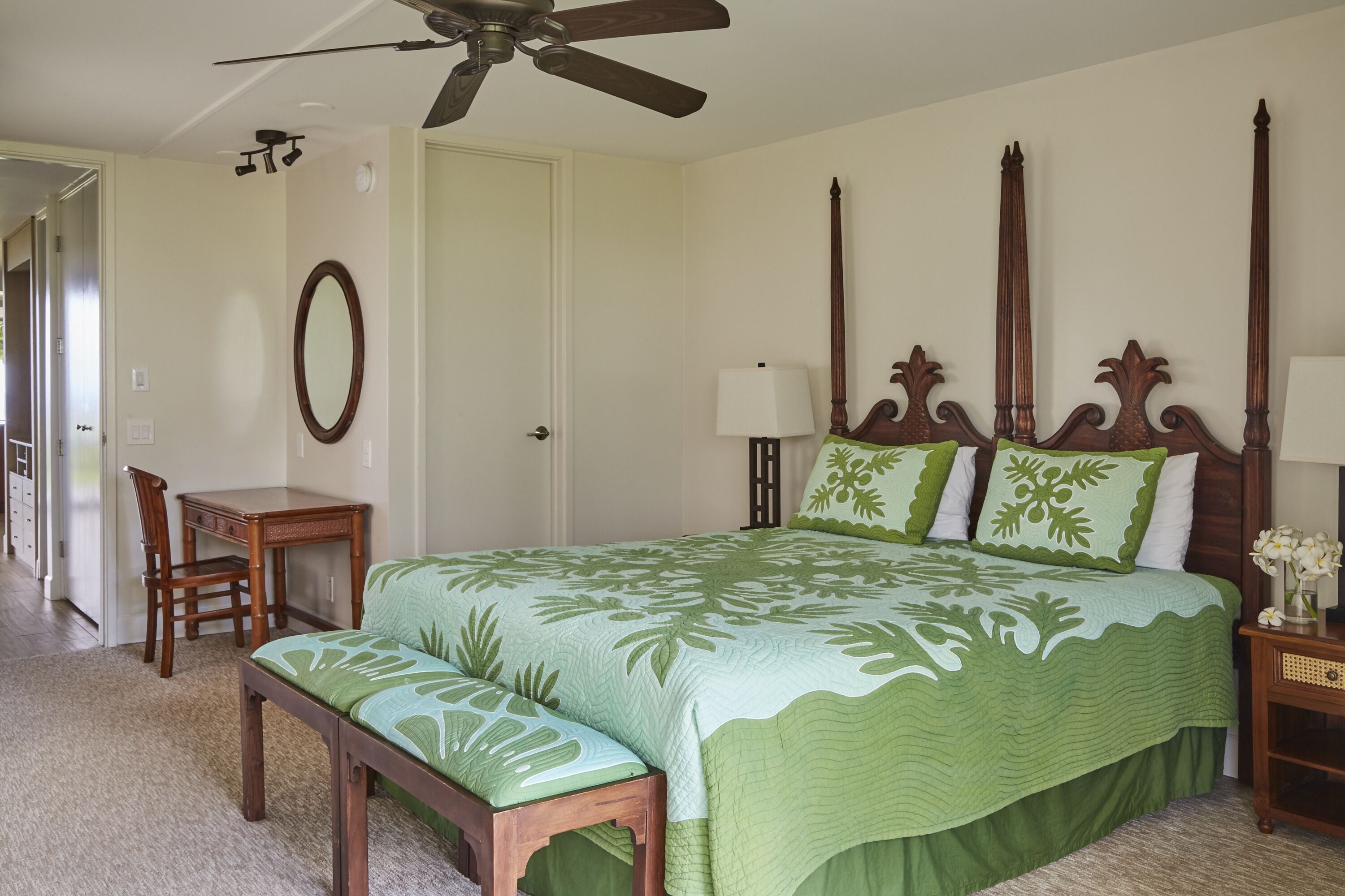 Un dormitorio con cama, una mesita de noche de madera, un escritorio y una silla.