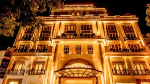 The exterior of the APRICOT HOTEL with a grand entrance, large columns, and balconies. - Apricot Hotel (Hanoi)
