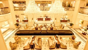 A spacious lobby with a central seating area, chandeliers, and a high ceiling. - Apricot Hotel (Hanoi)