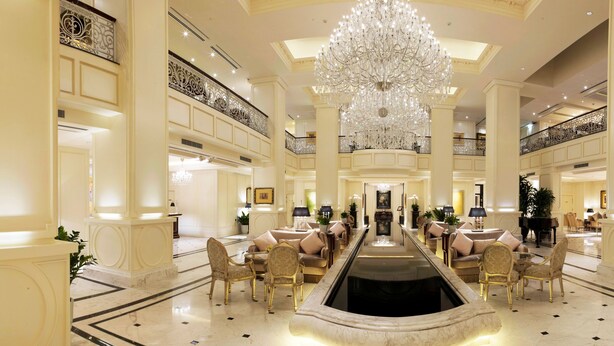 A grand lobby with a central water feature, elegant chandeliers, and classic furniture. - Apricot Hotel (Hanoi)