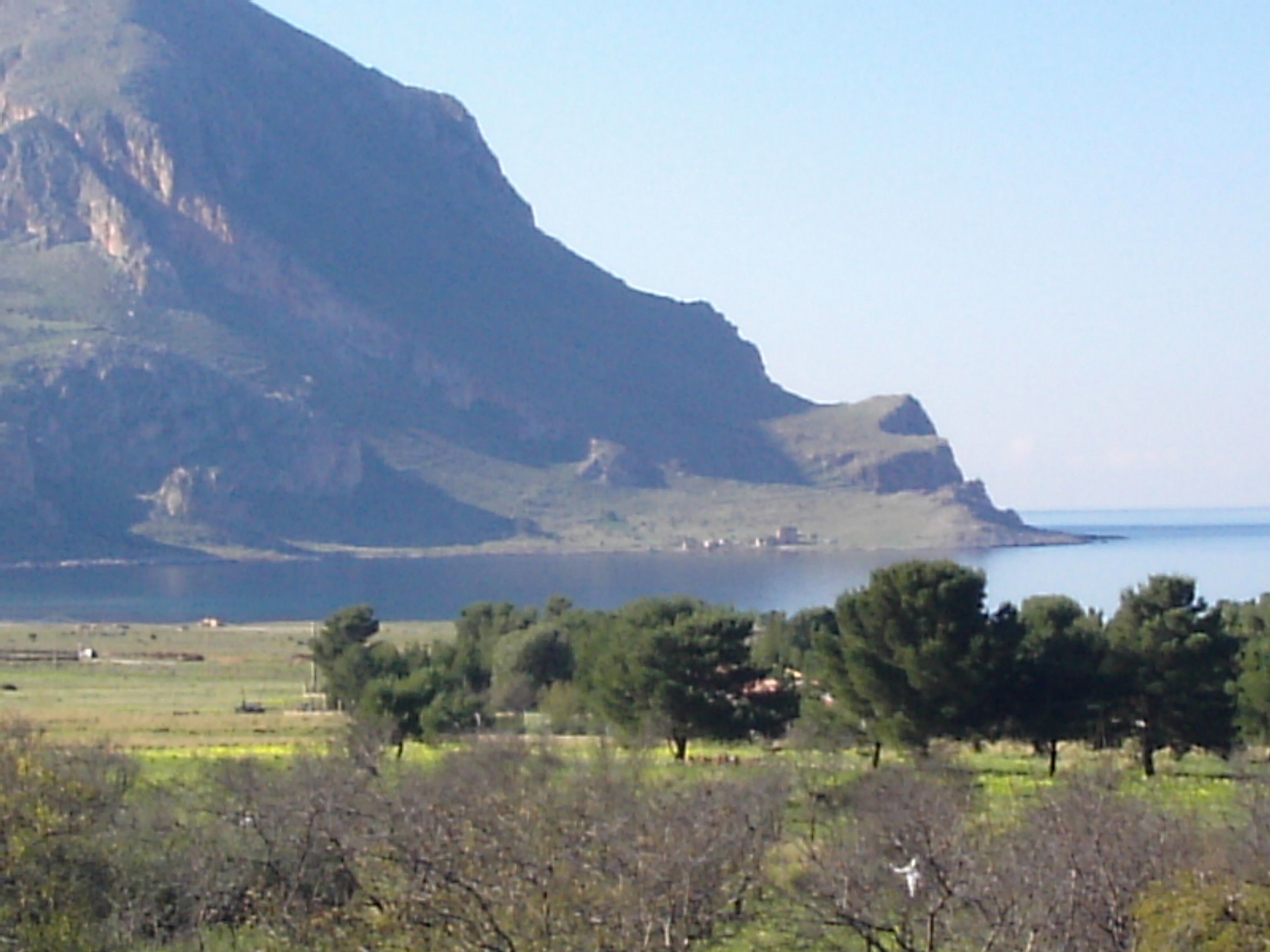 Paisaje montañoso con un cuerpo de agua al fondo.