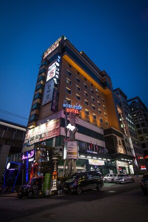 A multi-story hotel with illuminated signage, including a prominent 'NOBLESS HOTEL' sign. - Noblesse Tourist Hotel (Seoul)