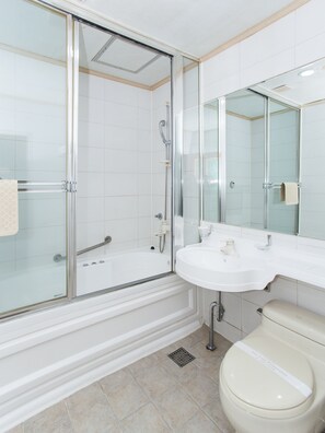A modern bathroom with a glass-enclosed shower, a white sink, and a toilet. - Noblesse Tourist Hotel (Seoul)