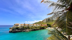 A coastal hotel with multiple buildings, a beach, and clear turquoise waters. - Lagun Blou Resort (Lagun)