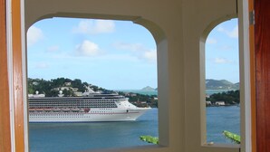 A view of a cruise ship docked at a port with a mountainous landscape in the background. - Bayside Villa St. Lucia (Castries)