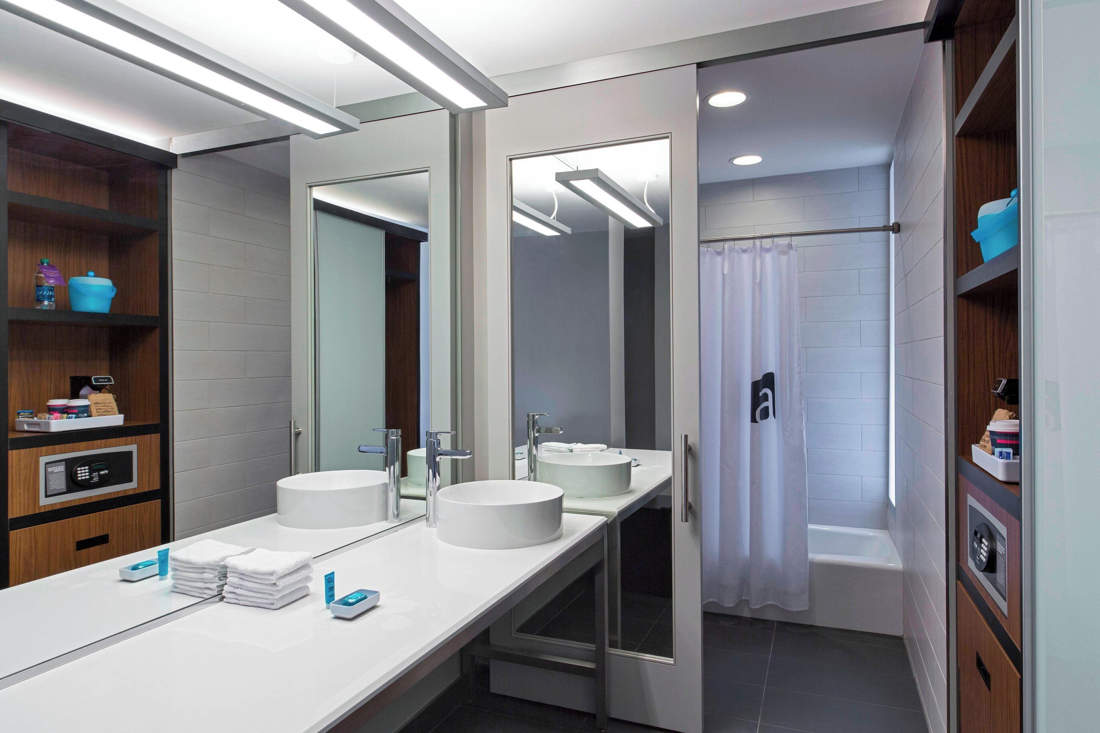 designer toiletries, hair dryer, towels