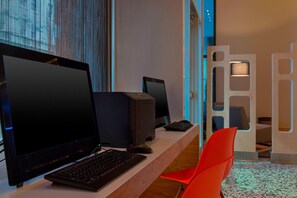 A modern workspace with a desktop computer, a monitor, and a keyboard. - Aloft by Marriott New Orleans Downtown (New Orleans)