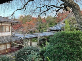 A traditional Japanese building with a tiled roof and wooden structure.