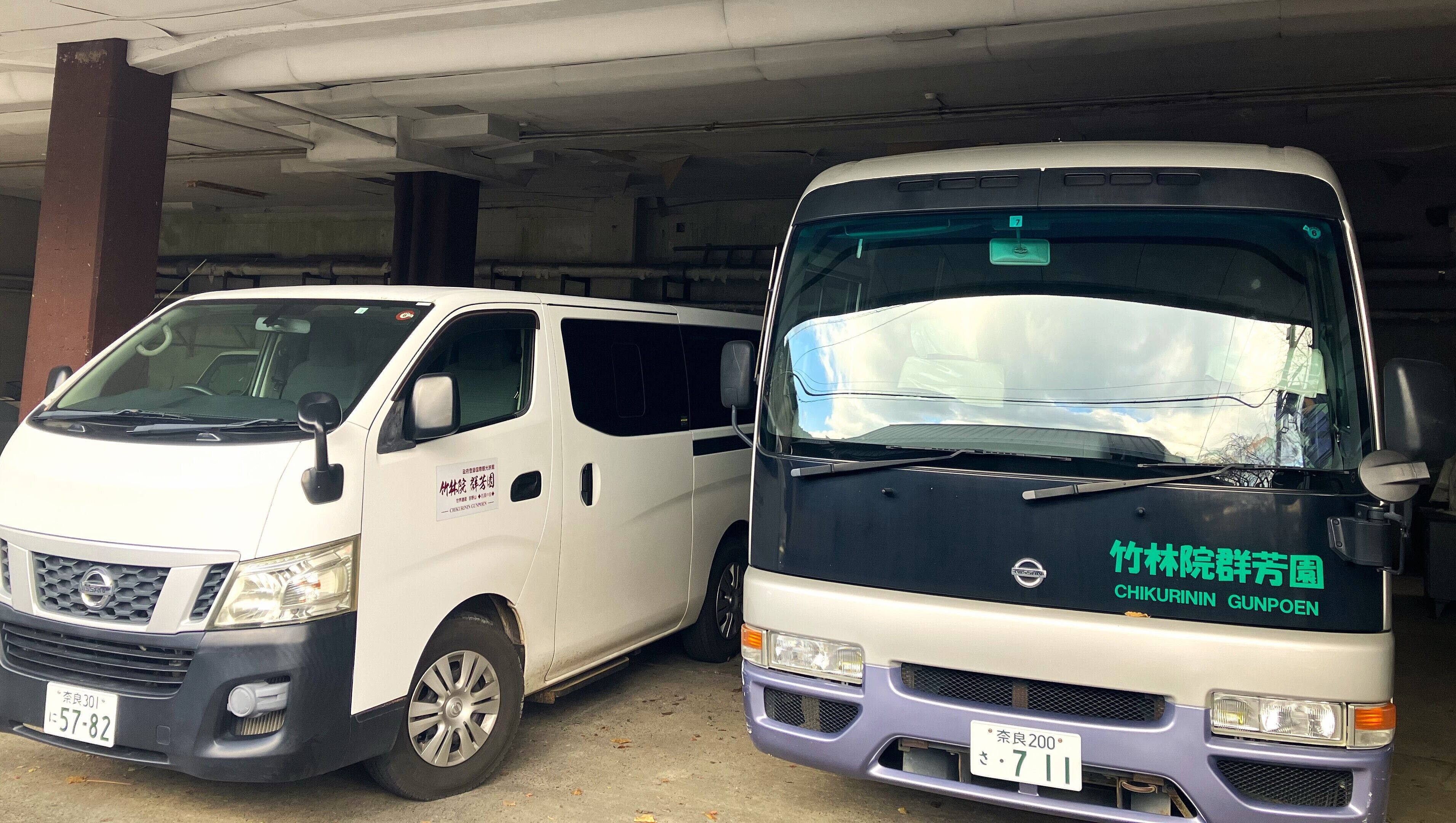 Two vehicles parked in a garage.