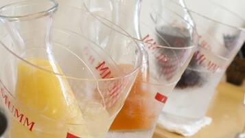 A series of measuring cups with different colored liquids.
