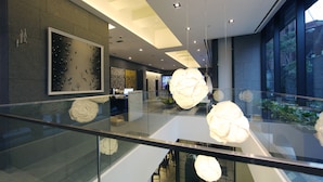 A modern interior with glass railings, contemporary lighting fixtures, and a view of the outdoors. - STAY B Hotel Myeongdong (Seoul)
