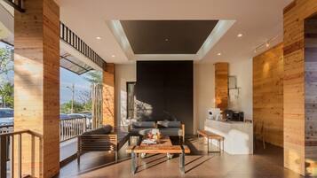 A modern living room with a sofa, coffee table, and a fireplace.