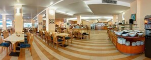 A spacious dining area with multiple tables and chairs, a central serving counter, and a striped floor pattern. - Hotel Slavuna (Kranevo)