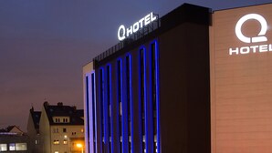 A hotel building with a prominent 'Q HOTEL' sign, featuring vertical blue lighting accents. - Q Hotel Kraków (Kraków)