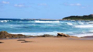 On the beach, surfing