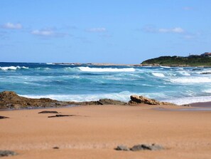 On the beach, surfing