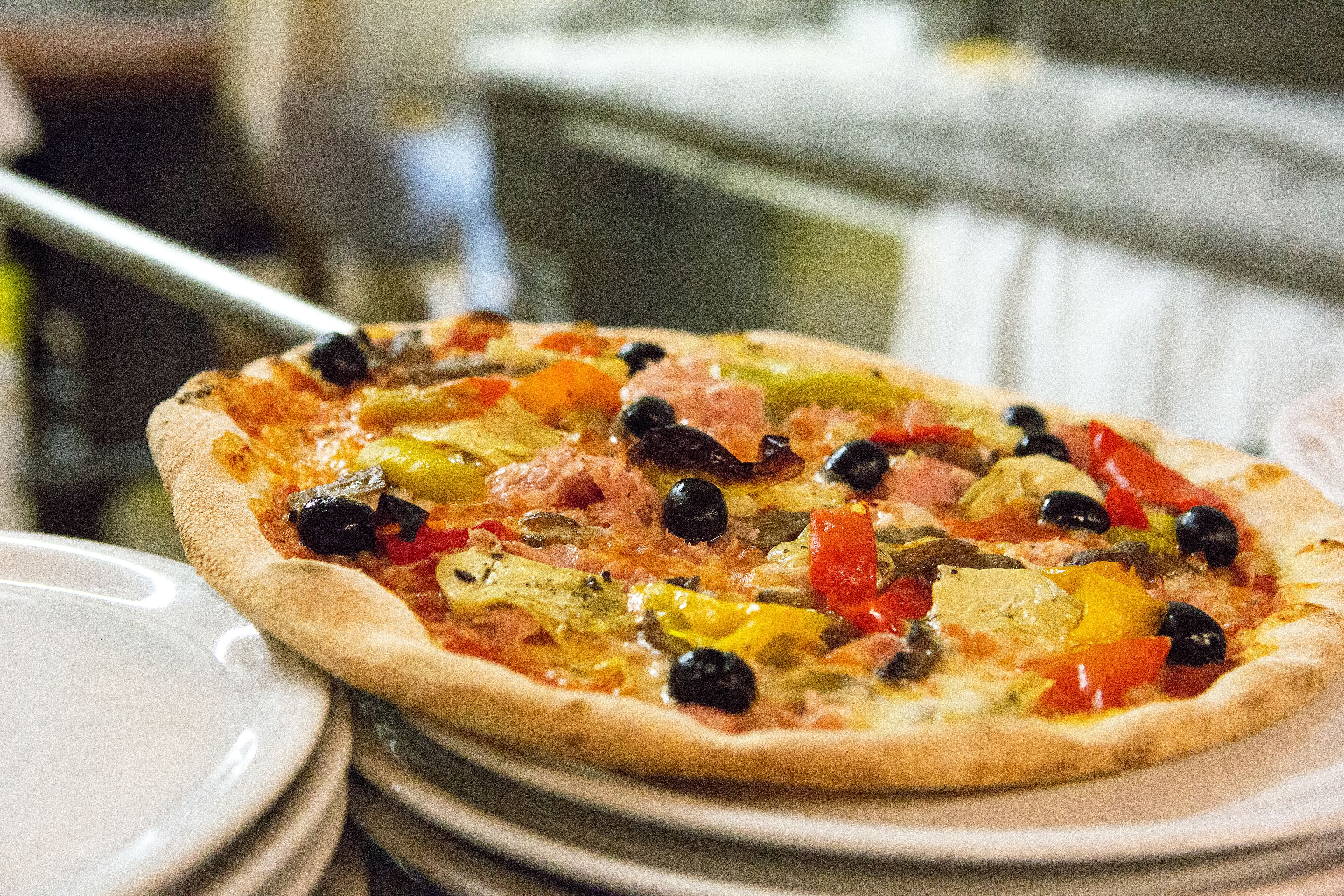 A pizza with various toppings on a plate.