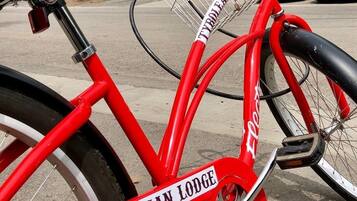Una bicicleta roja con una cesta y un cartel que dice "TYROLEAF LODGE".